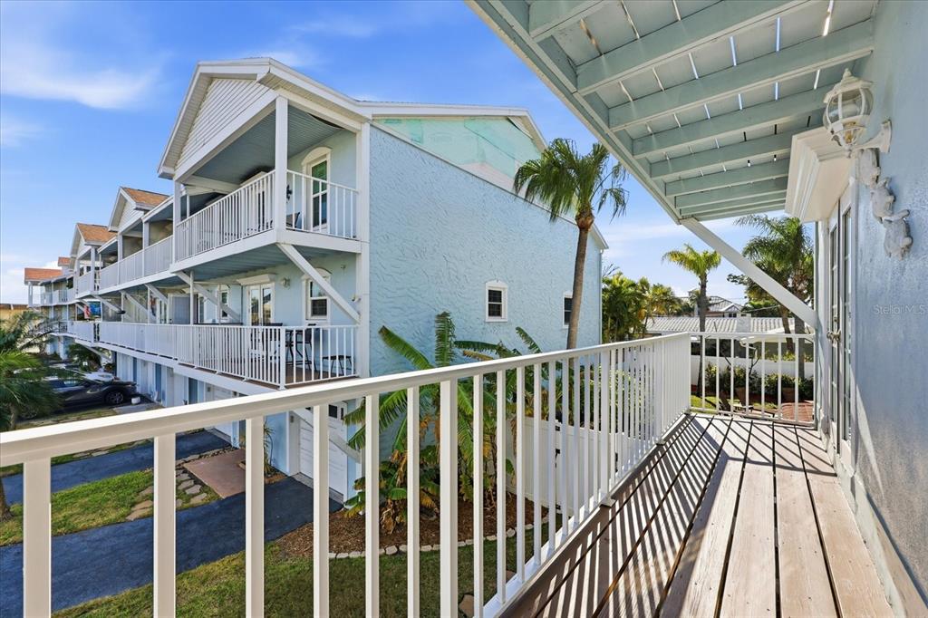9170 Blind Pass Road St. Pete Beach, FL 33706 - Photo 19 of 58 a view of a houses with a balcony