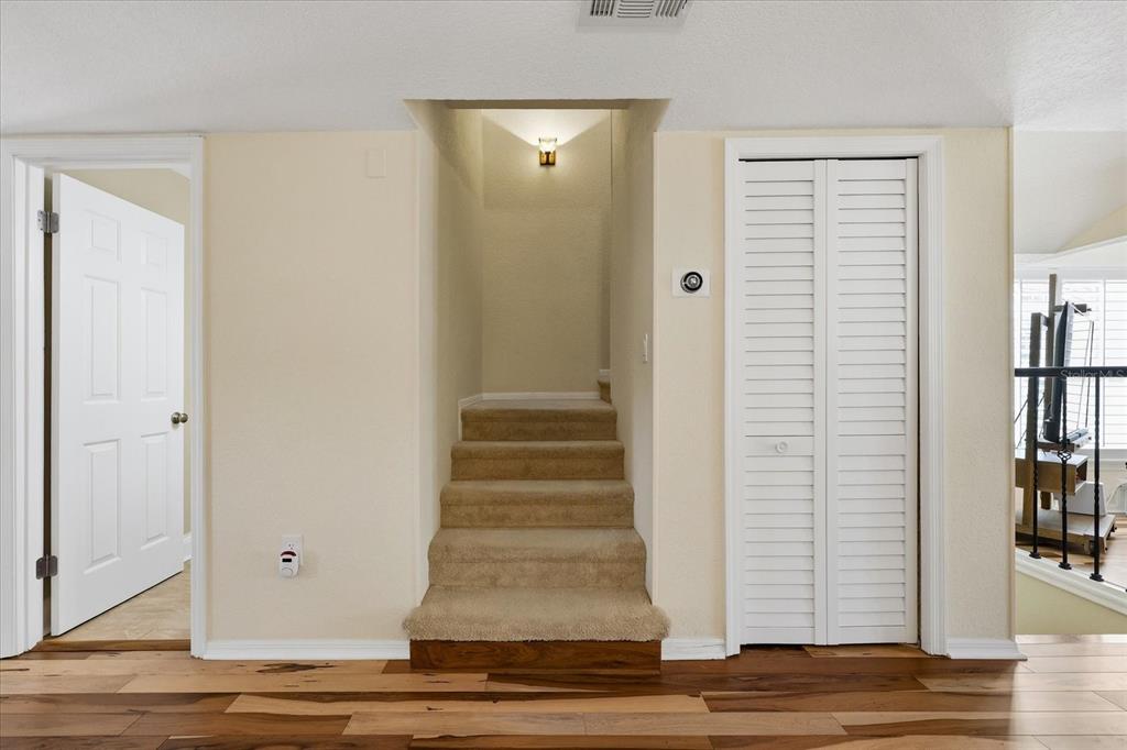 9170 Blind Pass Road St. Pete Beach, FL 33706 - Photo 20 of 58 a view of an entryway with wooden floor and staircase