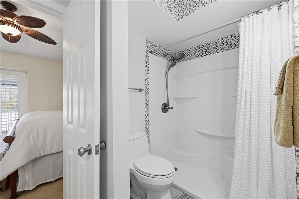 9170 Blind Pass Road St. Pete Beach, FL 33706 - Photo 25 of 58 a bathroom with a shower and a toilet