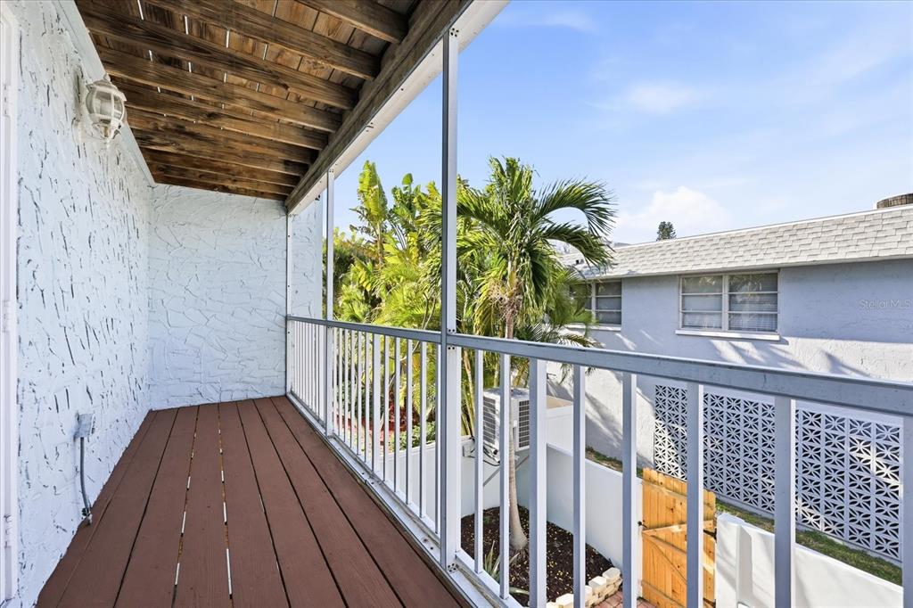 9170 Blind Pass Road St. Pete Beach, FL 33706 - Photo 28 of 58 a view of a balcony with wooden floor