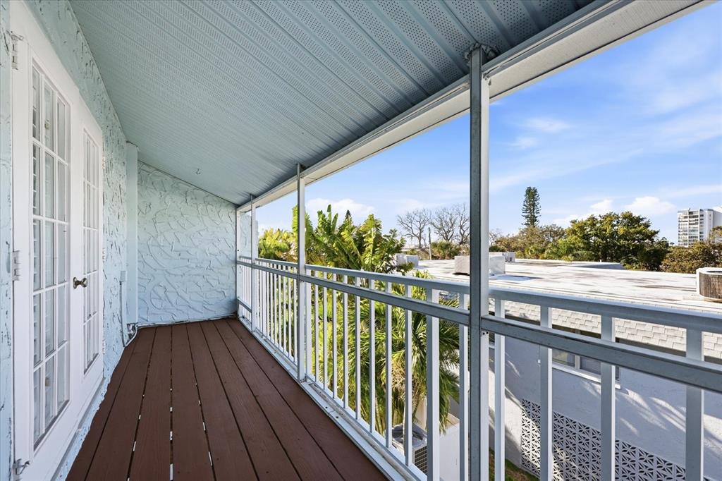 9170 Blind Pass Road St. Pete Beach, FL 33706 - Photo 29 of 58 a view of a balcony with wooden floor