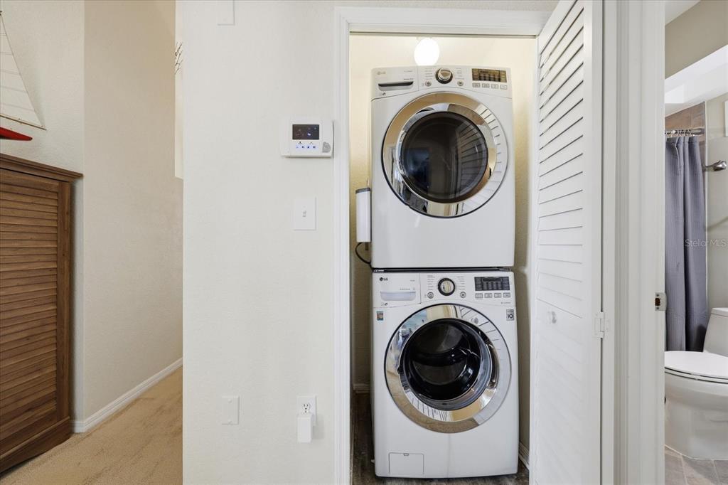9170 Blind Pass Road St. Pete Beach, FL 33706 - Photo 30 of 58 a utility room with dryer and washer