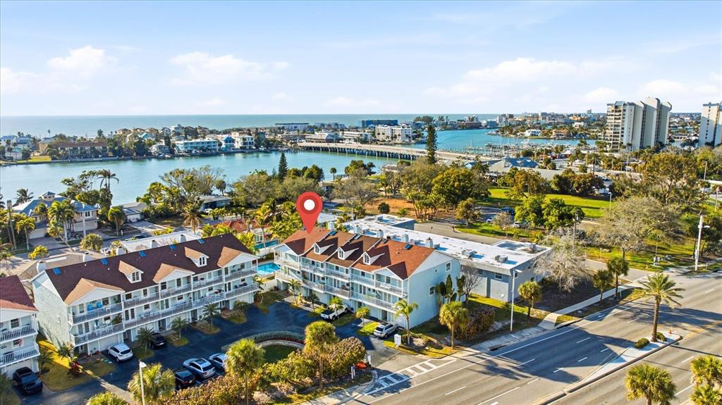 9170 Blind Pass Road St. Pete Beach, FL 33706 - Photo 3 of 58 an aerial view of a city with lots of residential buildings ocean and mountain view in back