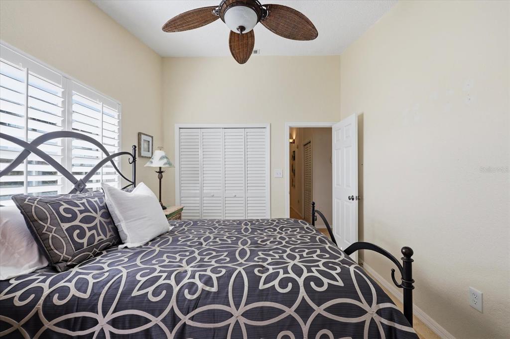 9170 Blind Pass Road St. Pete Beach, FL 33706 - Photo 31 of 58 a bedroom with a bed and a window