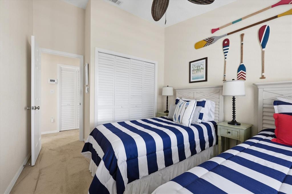 9170 Blind Pass Road St. Pete Beach, FL 33706 - Photo 33 of 58 a bedroom with bed and paintings on the wall