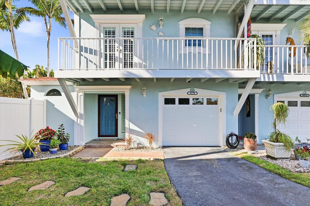 9170 Blind Pass Road St. Pete Beach, FL 33706 - Photo 39 of 58 a front view of a house with garden