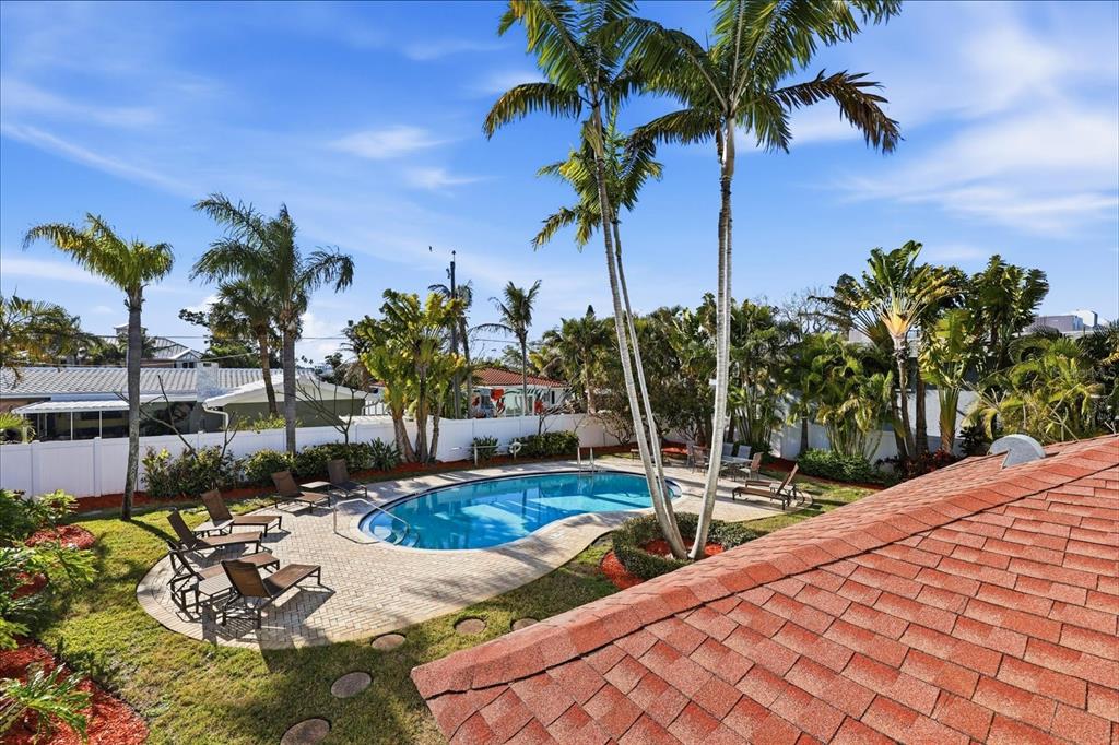 9170 Blind Pass Road St. Pete Beach, FL 33706 - Photo 42 of 58 a view of swimming pool with a table and chairs
