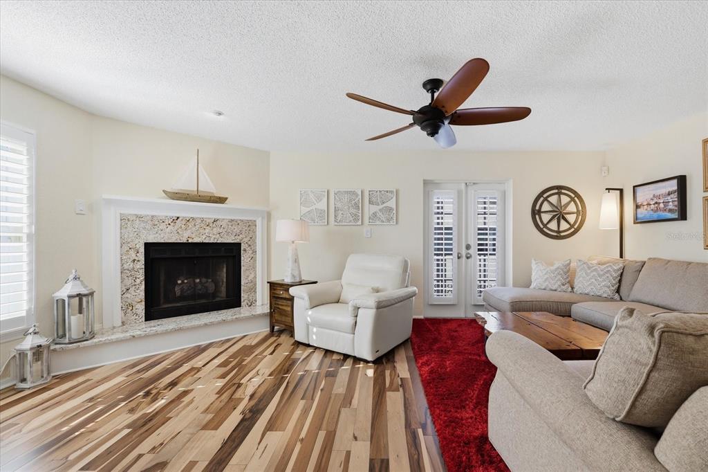 9170 Blind Pass Road St. Pete Beach, FL 33706 - Photo 8 of 58 a living room with furniture and a fireplace