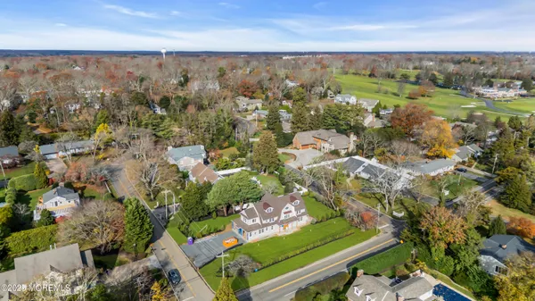 an aerial view of a houses with a yard