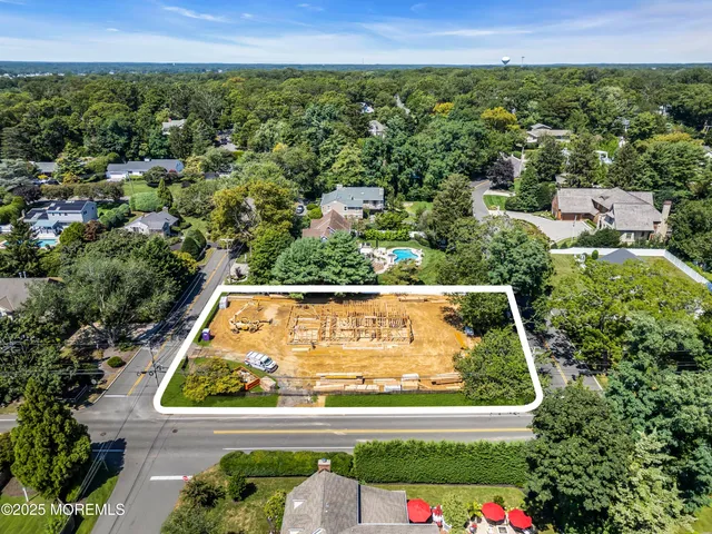 an aerial view of a large pool and red yard