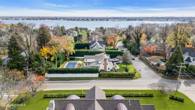an aerial view of a house with a garden and lake view
