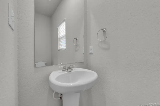 a bathroom with a sink and mirror