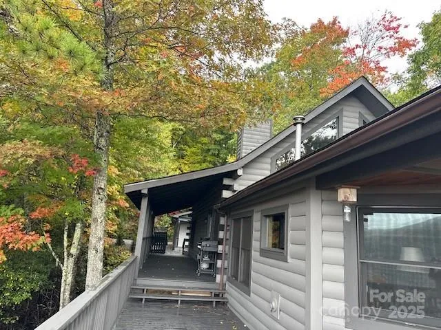 a view of a patio with couches chairs and wooden floor