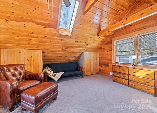 a spacious bedroom with a bed and a chandelier