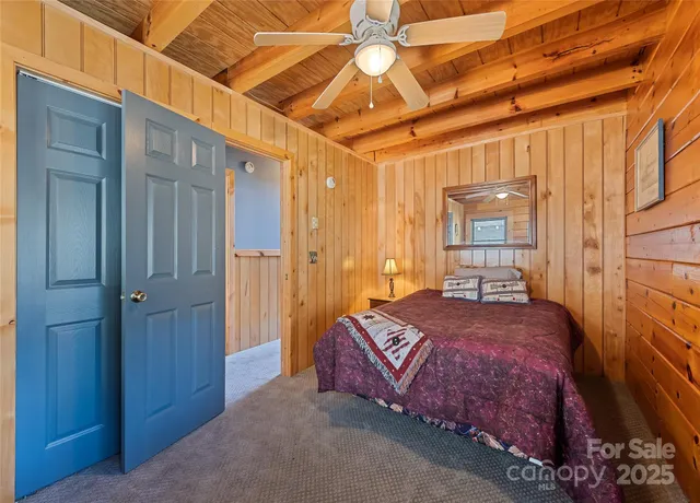 a bedroom with a bed dresser and a window