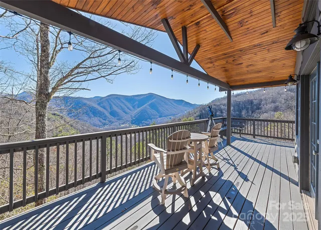 a view of a patio with table and chairs and wooden floor
