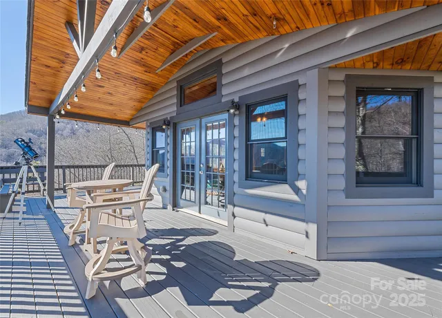 a view of balcony with mountain view and wooden floor