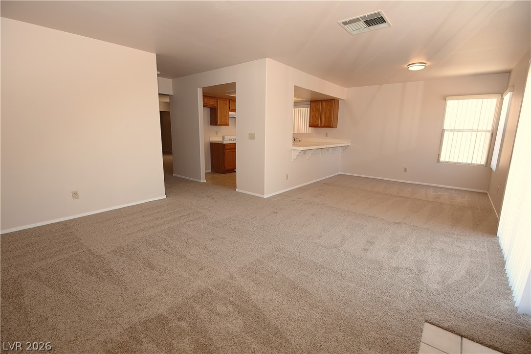 8220 Maplestar Road Las Vegas, NV 89128 - Photo 11 of 29 A versatile open-concept living area with a convenient kitchen pass-through.