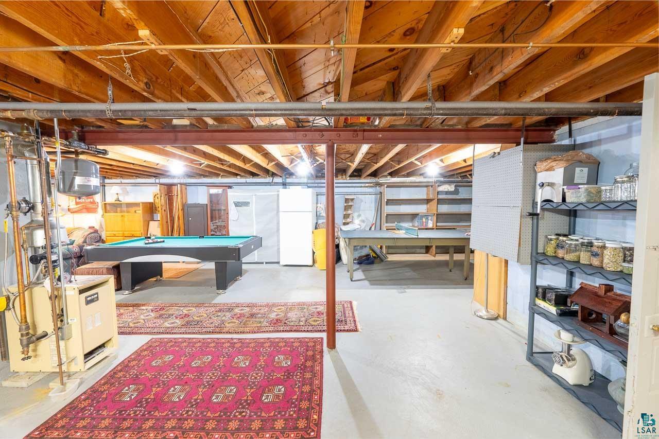 101 2nd Avenue North Biwabik, MN 55708 - Photo 23 of 44 Spacious lower level featuring exposed wood beam ceilings and a structural support beam