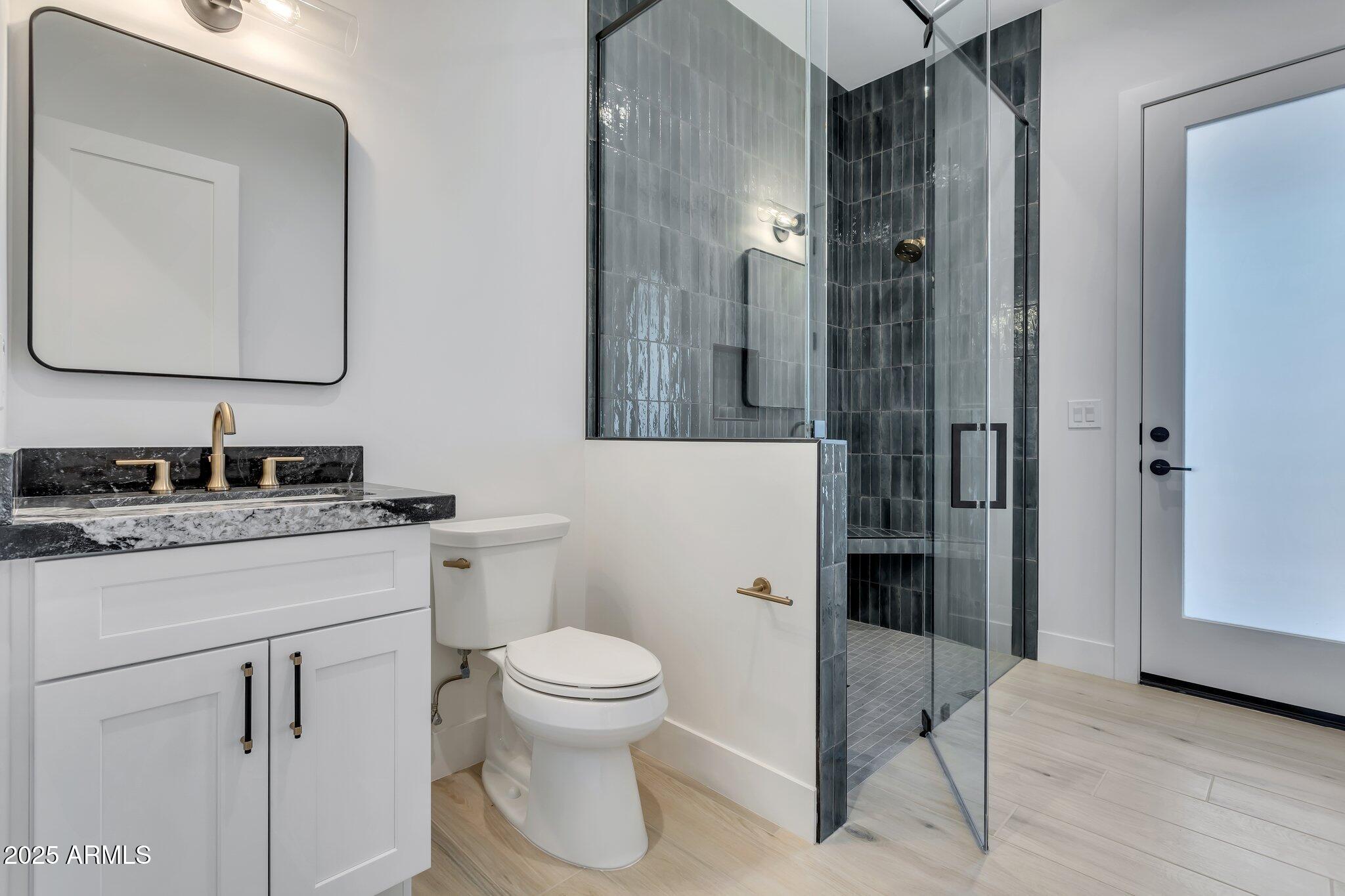 1602 East Cloud Road Phoenix, AZ 85086 - Photo 35 of 45 a bathroom with a toilet a sink and glass door