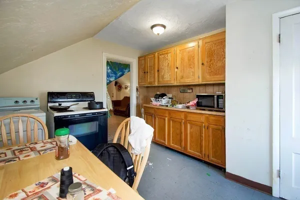 a kitchen with a refrigerator and a stove