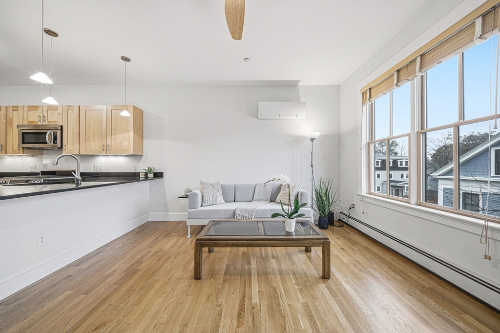190 Prospect Street, Unit 8 Cambridge, MA 02139 - Photo 11 of 32 a living room with furniture and a large window