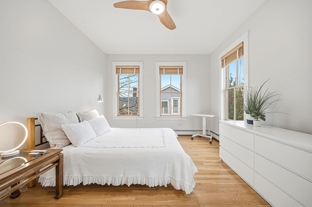 190 Prospect Street, Unit 8 Cambridge, MA 02139 - Photo 14 of 32 a spacious bedroom with a bed and a large window