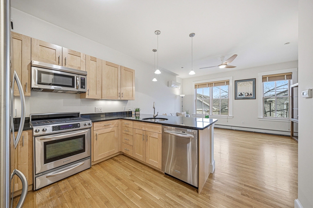 190 Prospect Street, Unit 8 Cambridge, MA 02139 - Photo 2 of 32 a kitchen with stainless steel appliances granite countertop a stove a sink and a microwave
