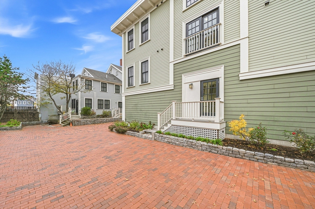 190 Prospect Street, Unit 8 Cambridge, MA 02139 - Photo 27 of 32 a front view of a house with a yard and garage