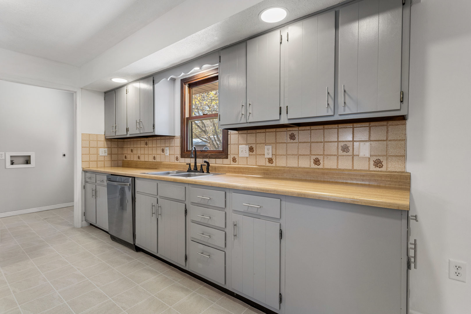 1201 Robin Road Mahomet, IL 61853 - Photo 13 of 33 a kitchen with cabinets appliances a sink and a window