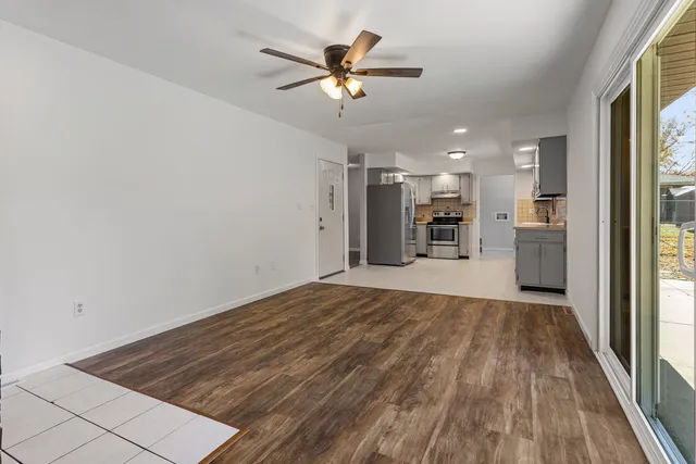 a view of a kitchen with a sink and a refrigerator