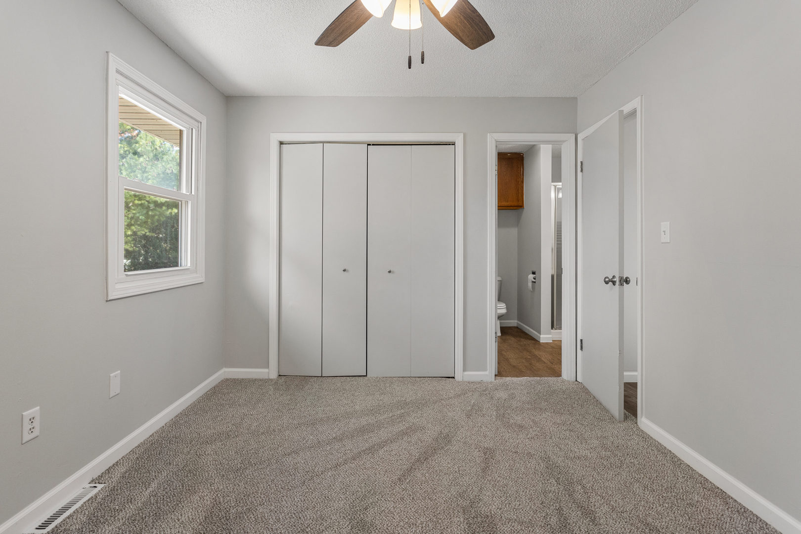 1201 Robin Road Mahomet, IL 61853 - Photo 22 of 33 an empty room with a window and a chandelier fan