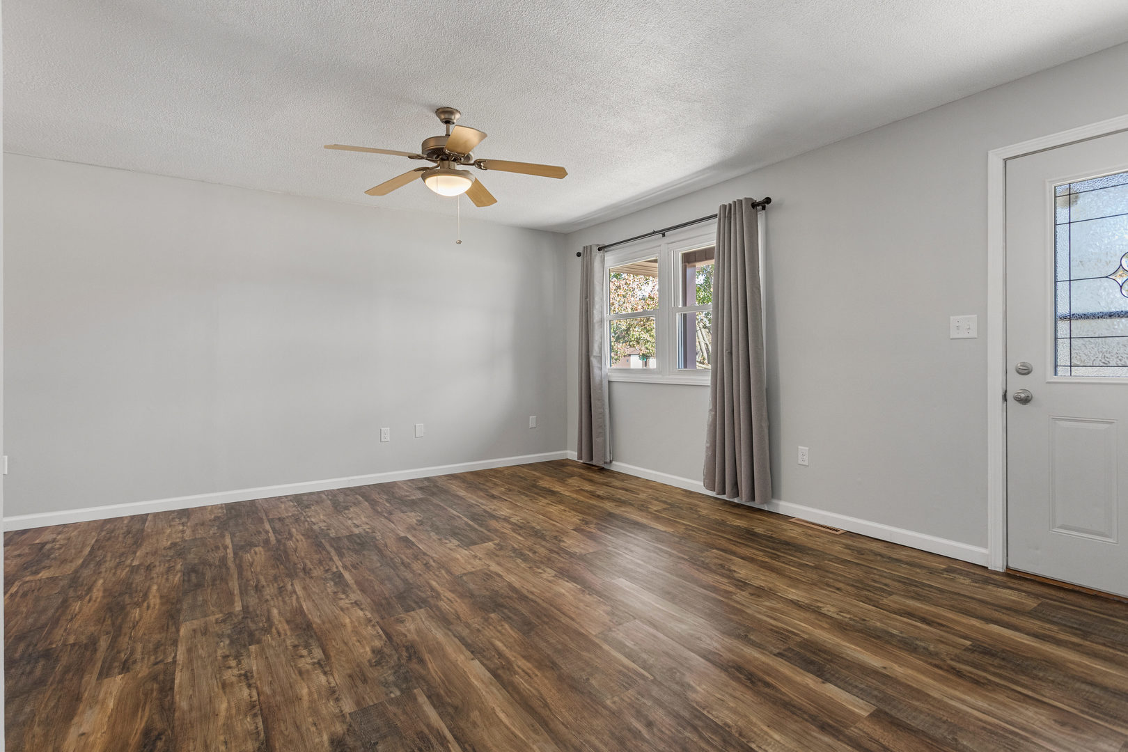 1201 Robin Road Mahomet, IL 61853 - Photo 6 of 33 a view of empty room with wooden floor and fan