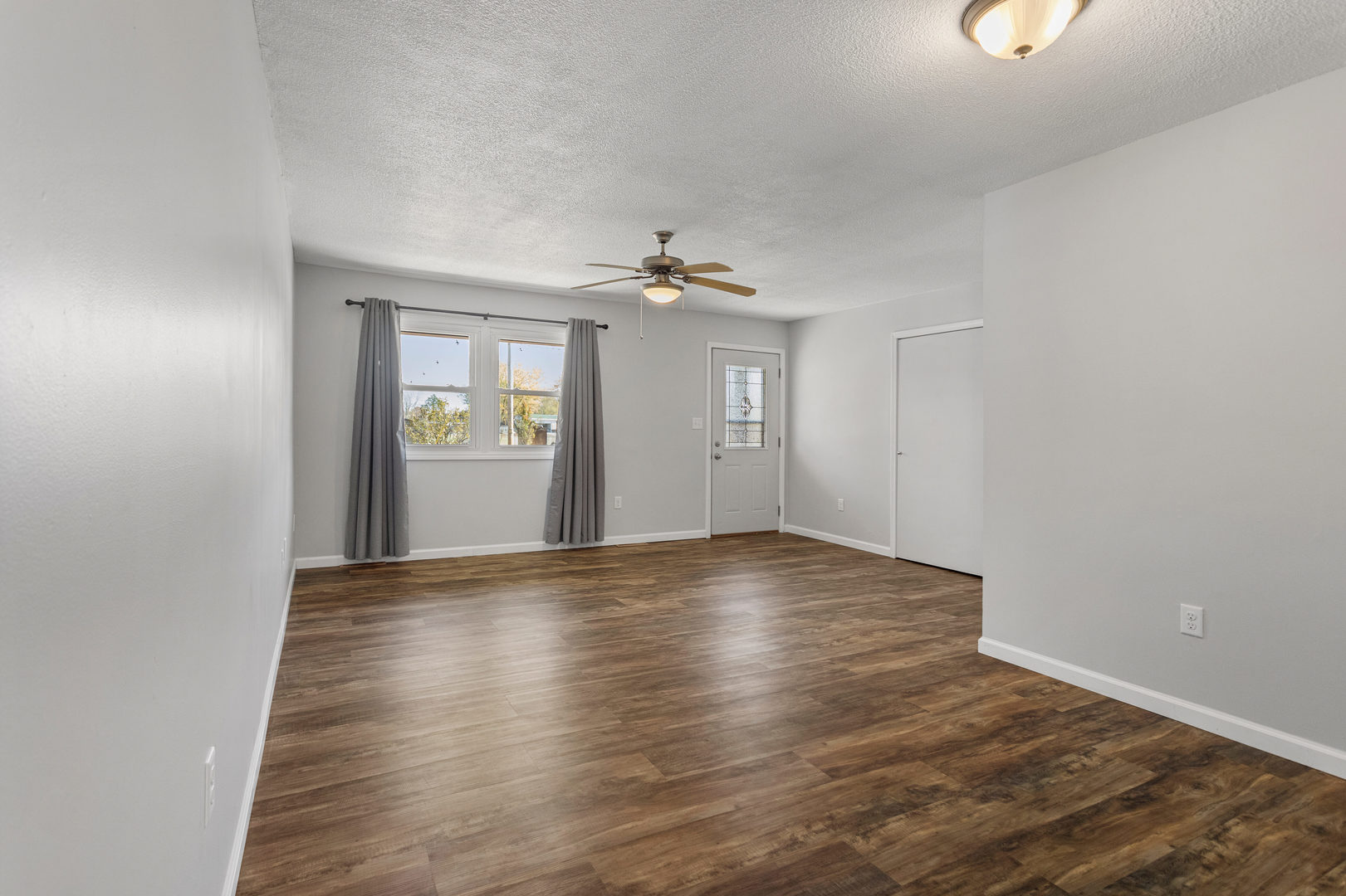 1201 Robin Road Mahomet, IL 61853 - Photo 7 of 33 a view of an empty room with a window and wooden floor