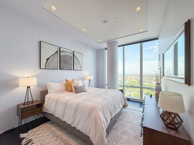 a bedroom with a large bed and a large window