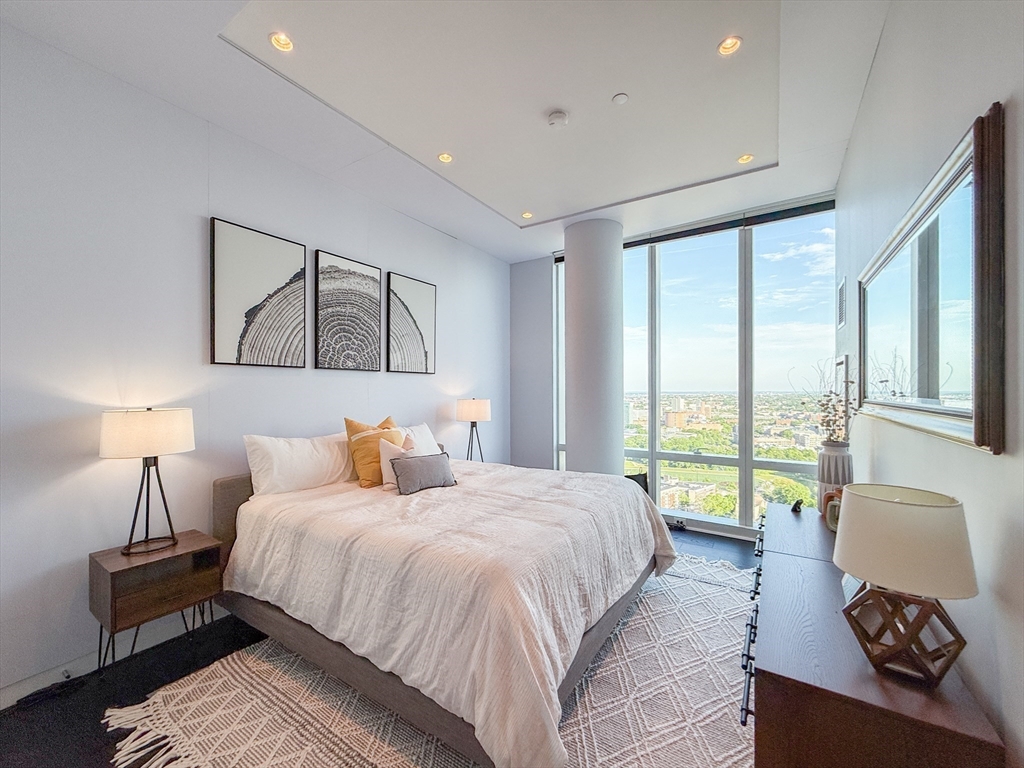 188 Brookline Avenue, Unit PH29A Boston, MA 02215 - Photo 20 of 42 a bedroom with a large bed and a large window