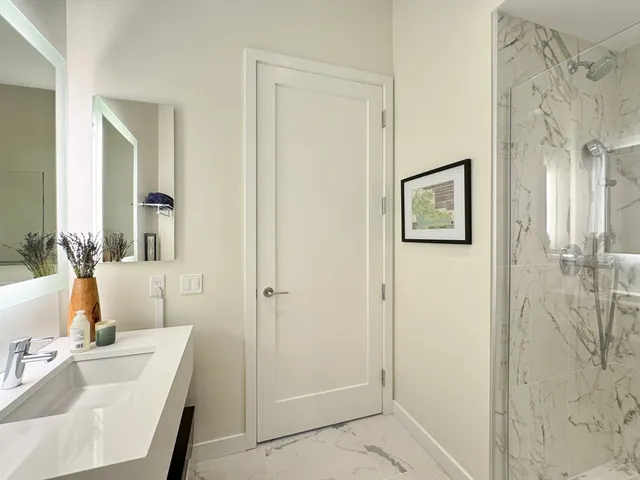a bathroom with a tub sink and mirror