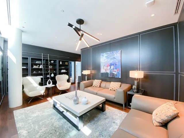 a view of a room with gym equipment and large tree