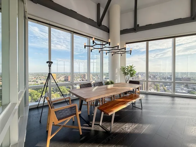 a view of a workspace with furniture and window