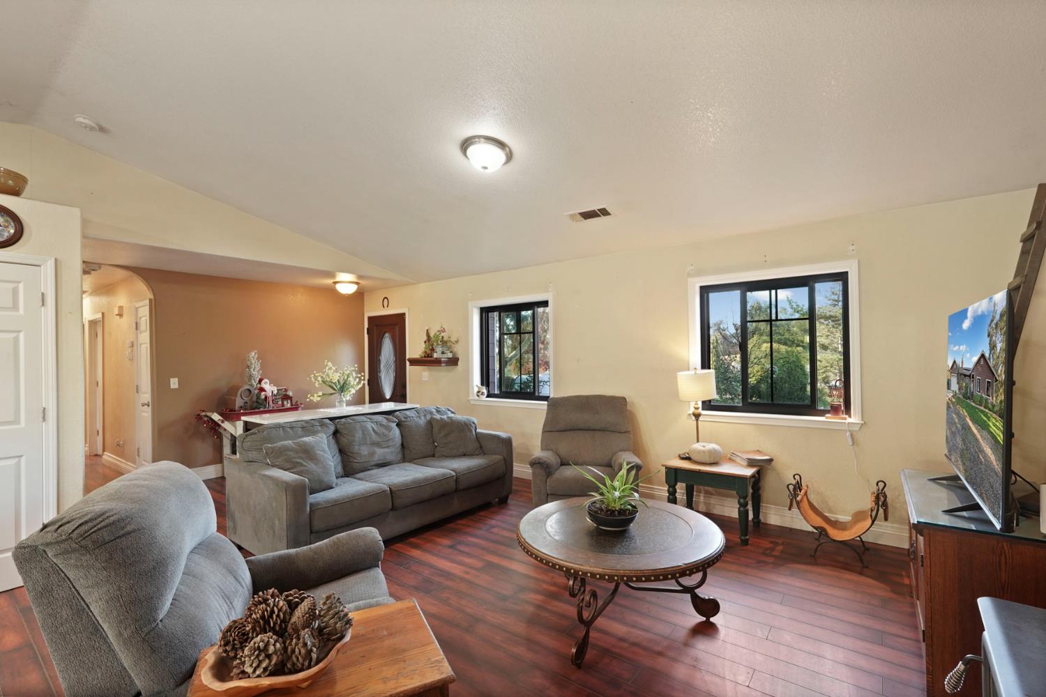 7505 Baldwin Street Valley Springs, CA 95252 - Photo 11 of 45 a living room with furniture a window and a flat screen tv