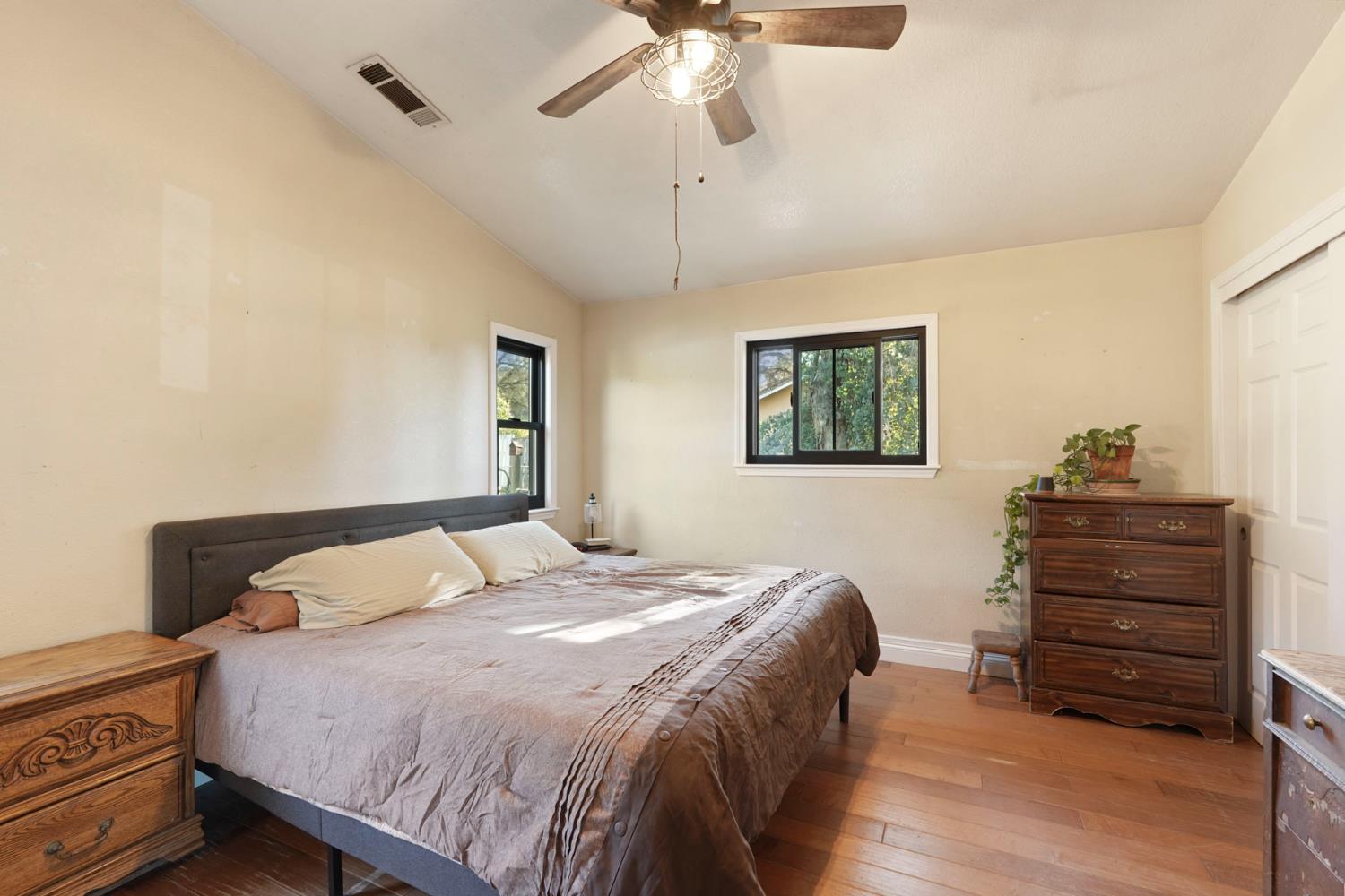 7505 Baldwin Street Valley Springs, CA 95252 - Photo 25 of 45 a bedroom with a bed and a chandelier