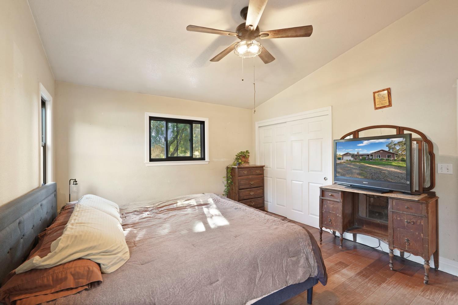 7505 Baldwin Street Valley Springs, CA 95252 - Photo 26 of 45 a bedroom with a bed and a chandelier