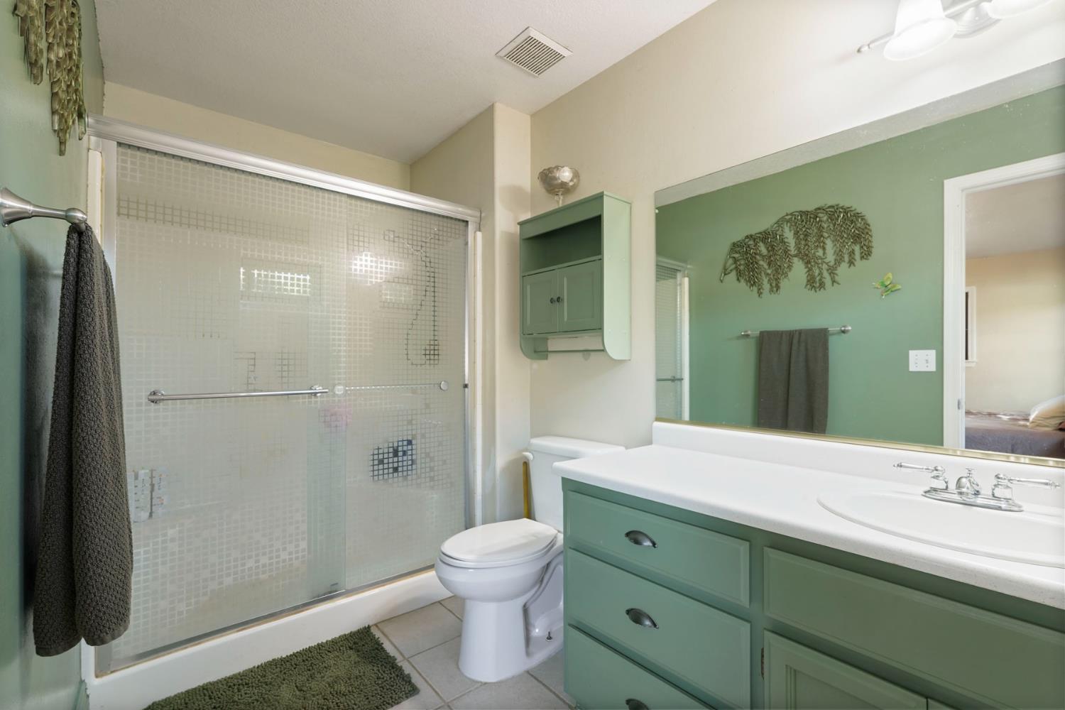7505 Baldwin Street Valley Springs, CA 95252 - Photo 28 of 45 a bathroom with a granite countertop sink toilet and shower