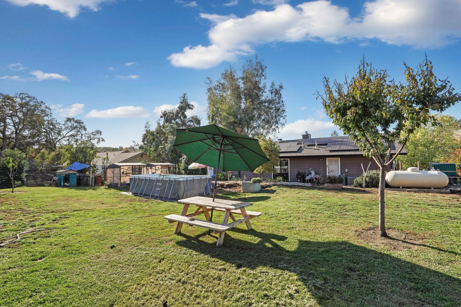 7505 Baldwin Street Valley Springs, CA 95252 - Photo 37 of 45 a view of a house with swimming pool and sitting area