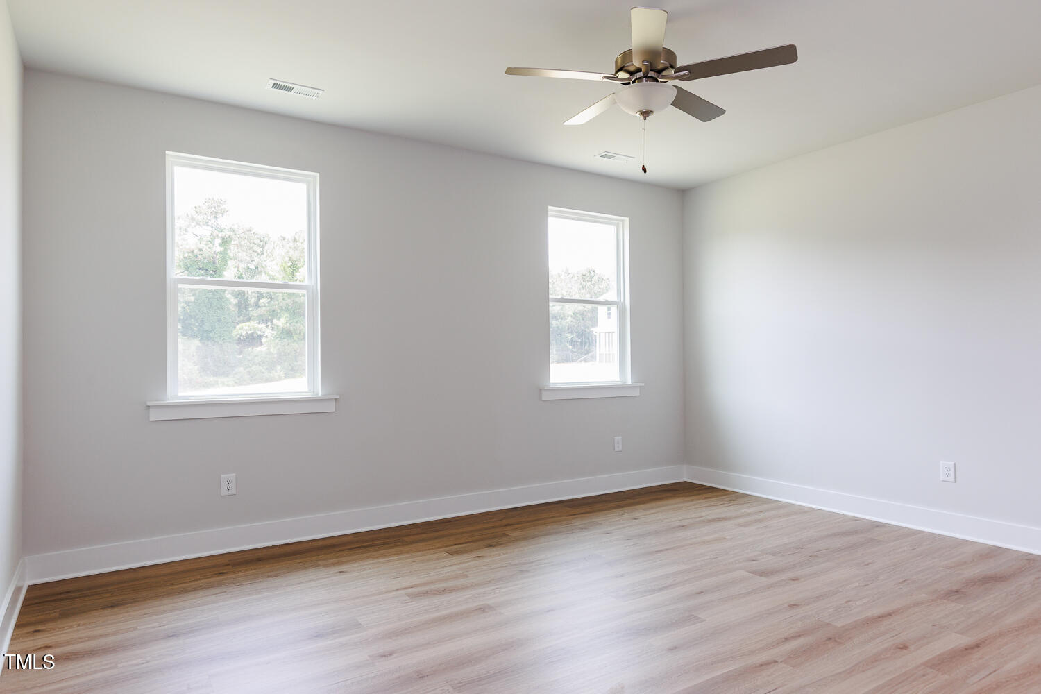 207 Golfview Avenue Four Oaks, NC 27524 - Photo 11 of 37 wooden floor in an empty room with a window
