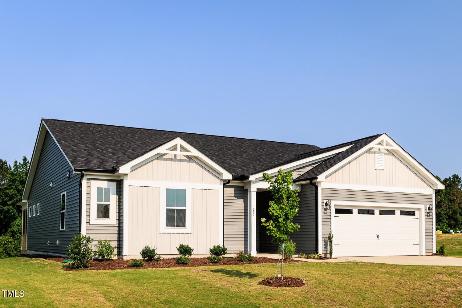 207 Golfview Avenue Four Oaks, NC 27524 - Photo 4 of 37 a front view of a house with a yard