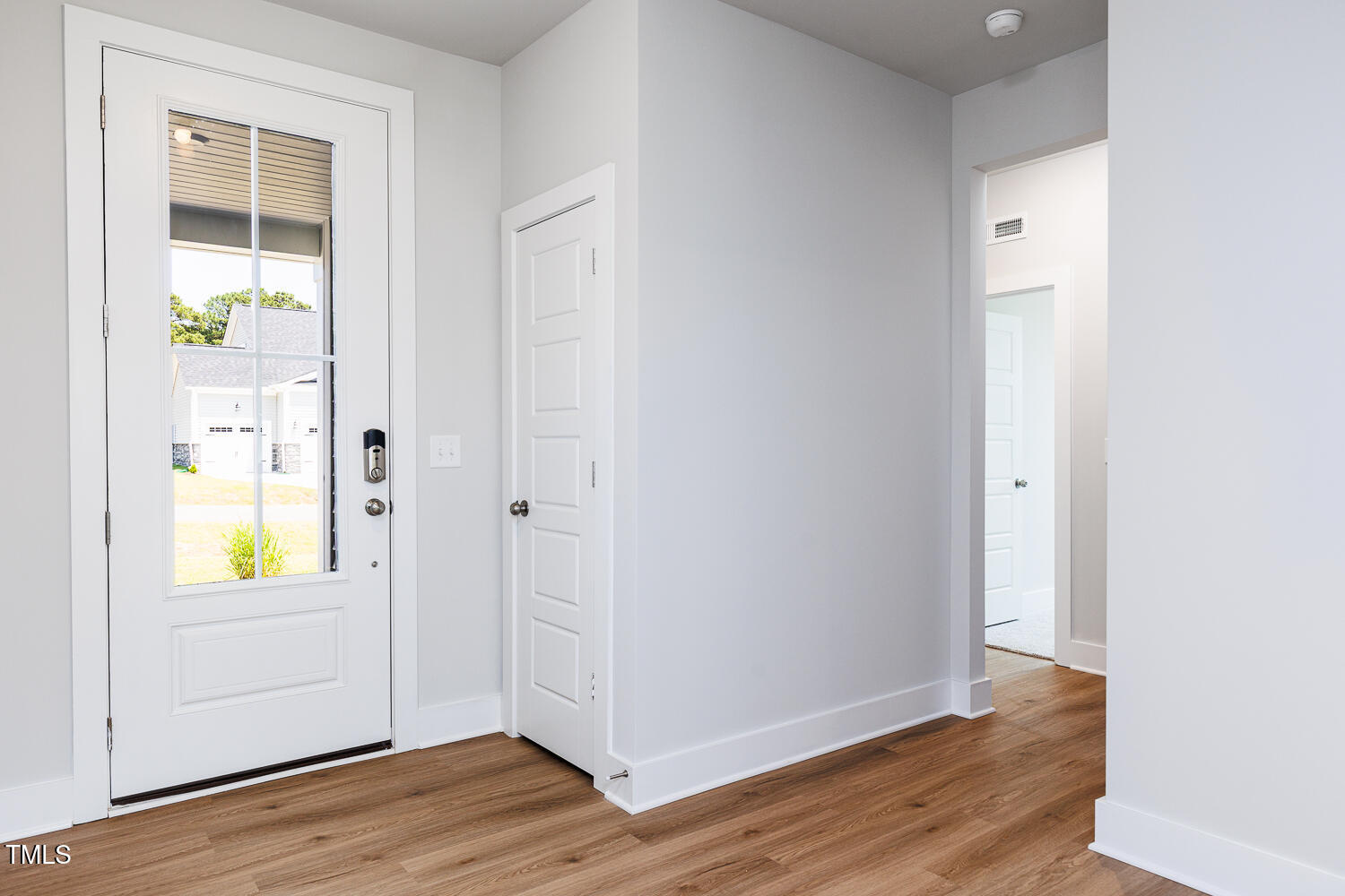 207 Golfview Avenue Four Oaks, NC 27524 - Photo 5 of 37 an empty room with wooden floor and a window