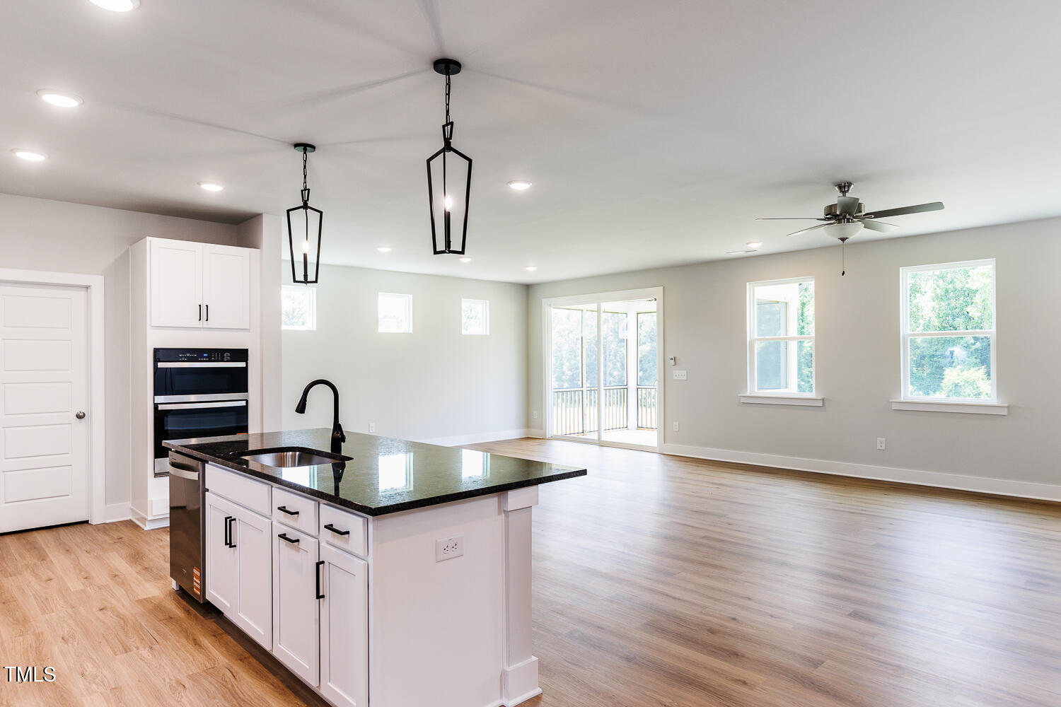 207 Golfview Avenue Four Oaks, NC 27524 - Photo 8 of 37 a kitchen with stainless steel appliances granite countertop a sink a stove and a wooden floors
