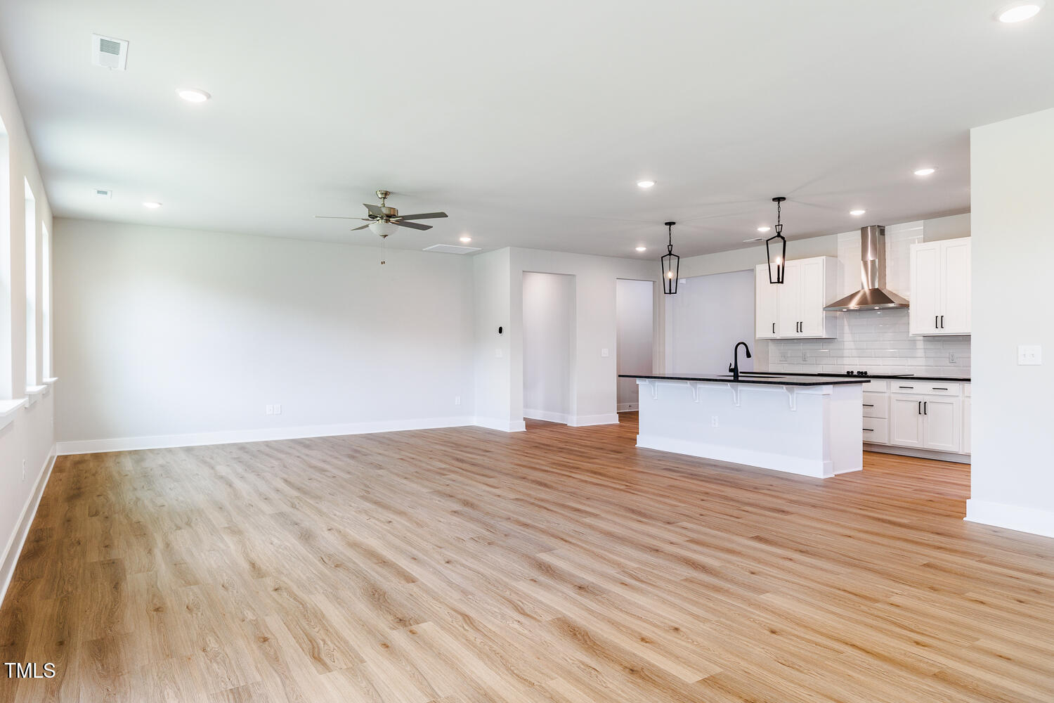 207 Golfview Avenue Four Oaks, NC 27524 - Photo 10 of 37 a view of kitchen with kitchen island a sink dishwasher and a stove with wooden floor