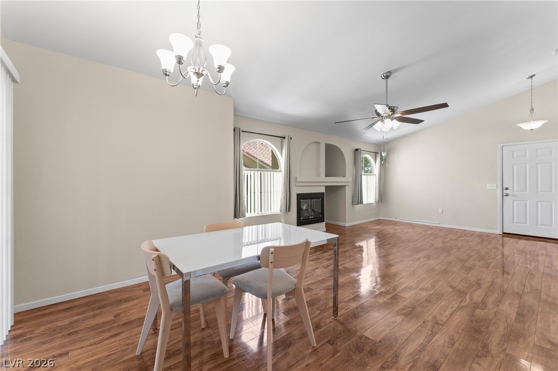 7950 West Flamingo Road, Unit 2142 Las Vegas, NV 89147 - Photo 10 of 24 A welcoming living space features warm hardwood floors and a cozy fireplace, perfect for intimate gatherings.